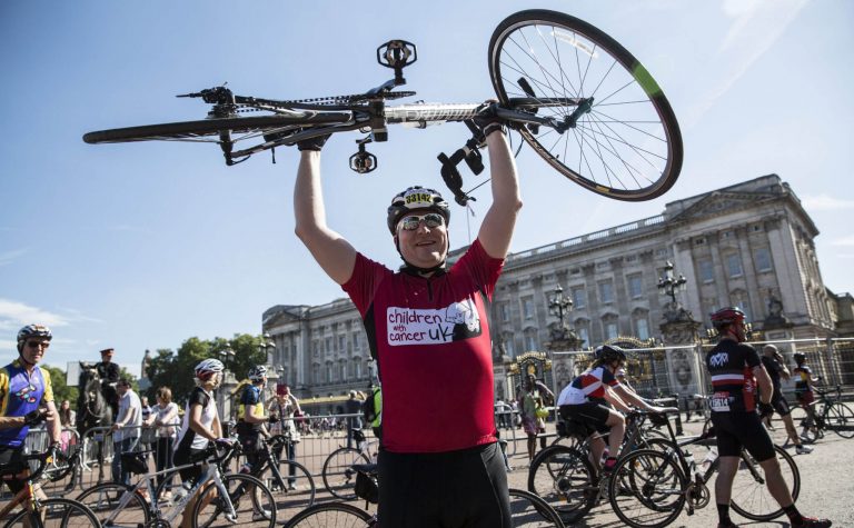 cyclist holding the bicycle up in the air