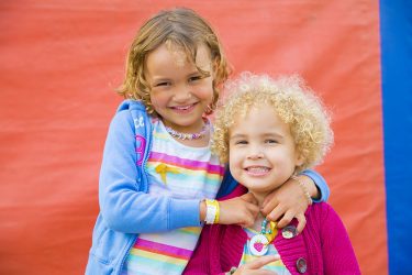 Phoebe, a childhood cancer survivor, with her sister