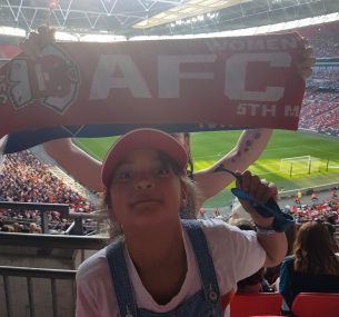 Girl at football match with cap