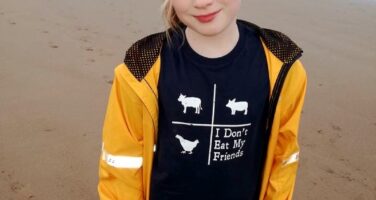 girl in yellow jacket by the beach