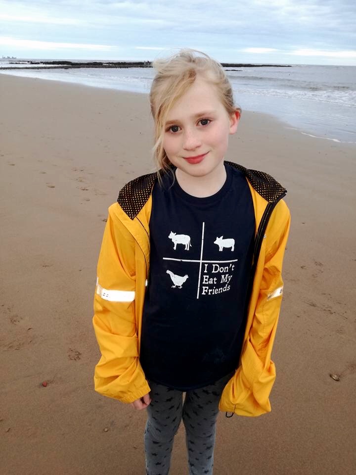 girl in yellow jacket by the beach