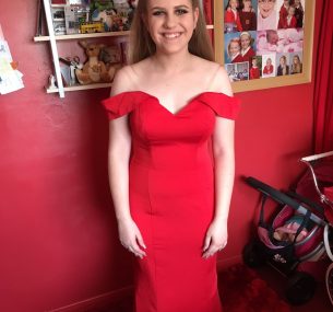 teenage girl in long red off the shoulder dress