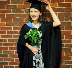 Woman graduating with flowers