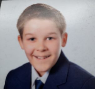 cameron boy with school uniform smiling