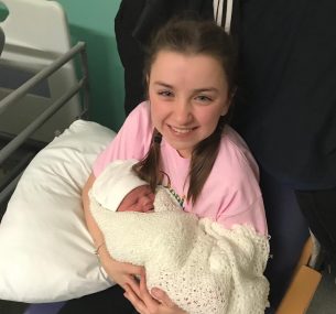 Girl holding baby