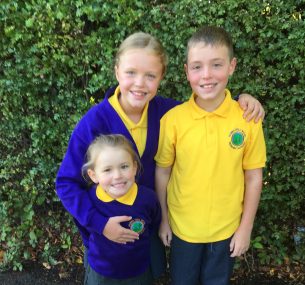 children in school uniform with yellow shirts