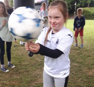 Girl with a football spinning