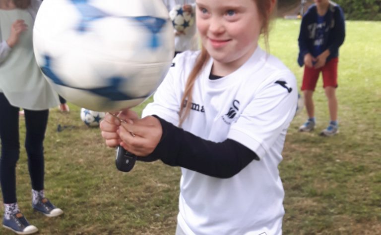 Girl with a football spinning