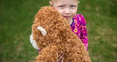 Eva hugging her teddy bear