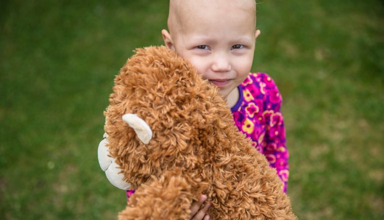 Eva hugging her teddy bear