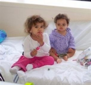 Jemma sat on a bed with her sister.