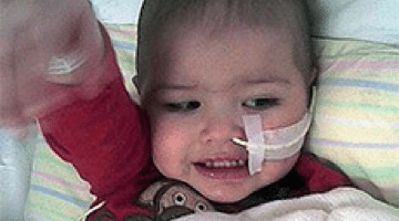 Joshua receiving treatment in bed.