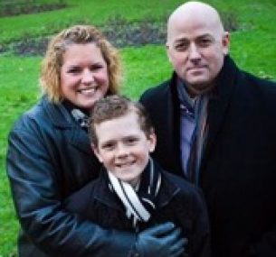 Kalem, smiling, gathered with his family.
