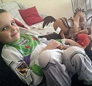 Kodie smiles, wearing a Buzz Lightyear costume