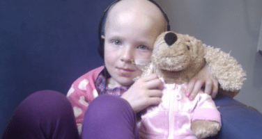 Kidney cancer survivor Niamh, holds a cuddly toy