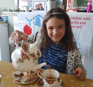 Girl with teapot pouring tea