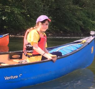 Tara girl in a blue canoe boat