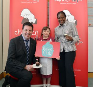 Two adults and a young girl with cup cakes