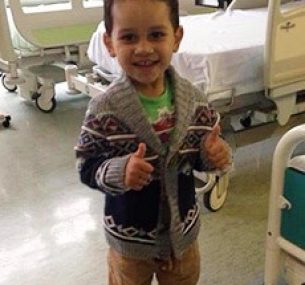 Benji smiling in hospital after treatment for leg leukaemia