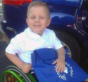 Blake smiling in his wheelchair