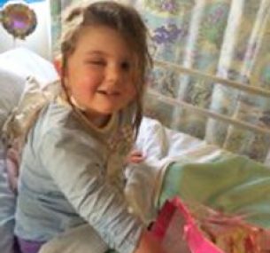 young girl in hospital bed because of brain tumour seizures