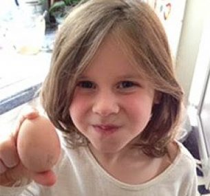 girl holding an egg