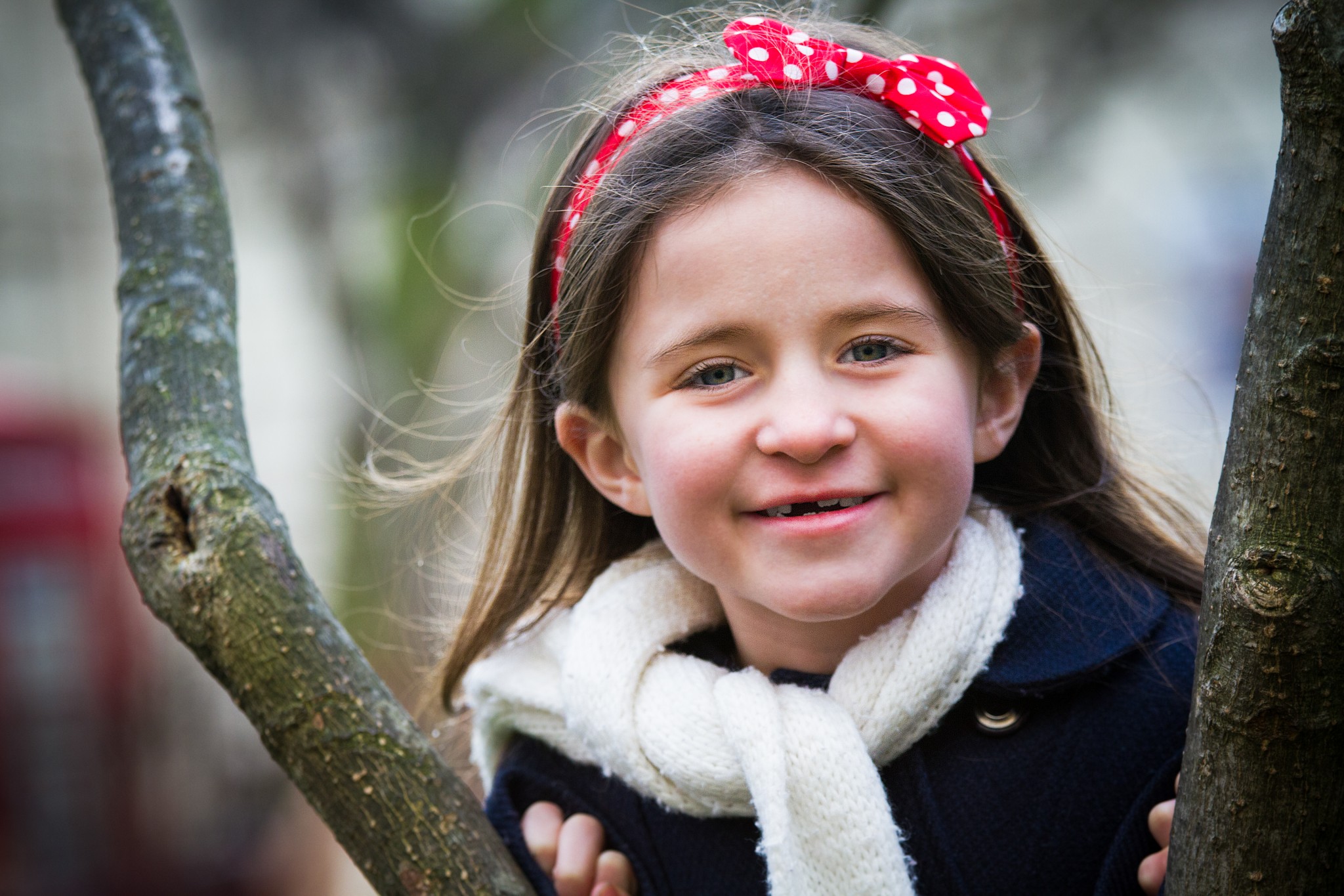 A young girl poses in a park