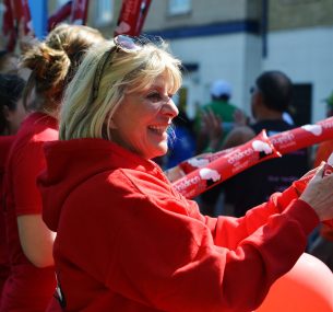 Women cheering people running London marathon for charity