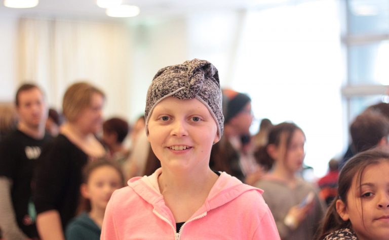 A young girl wearing pink