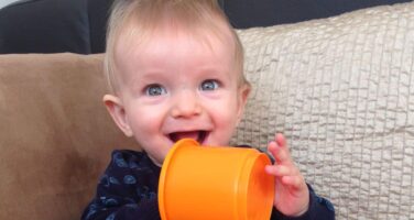 Albie baby boy with orange cup