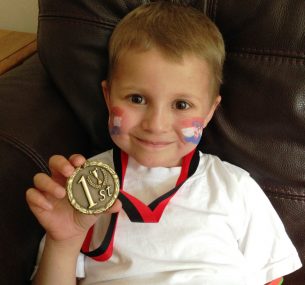 Jacob with medal at school sport event