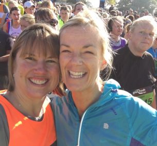 Two girls posing after running a half marathon