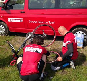 Two cyclists repair a puncture