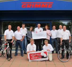 The Grimme cycling team with a cheque