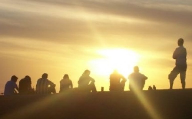 People sitting at sunset