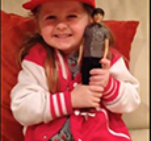 little girl holding an action figure