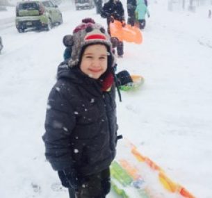 a boy playing in the snow