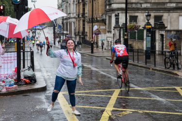 charity supporter during a rainy Ride London event