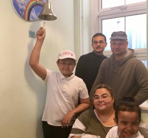 Dylan's family watch as he rings the End of Treatment Bell.