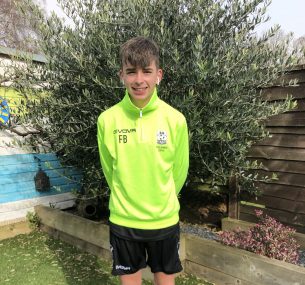 Boy in green football gear