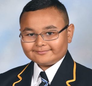 School photo of boy with glasses and blazer and tie