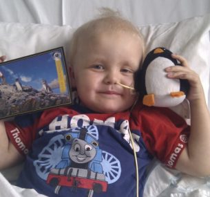 Alex in hospital with his gifts