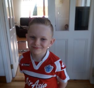 boy wearing red football shirt