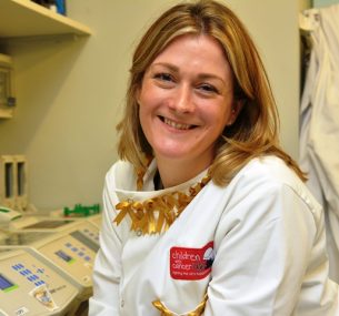 Researcher smiling wearing a lab coat