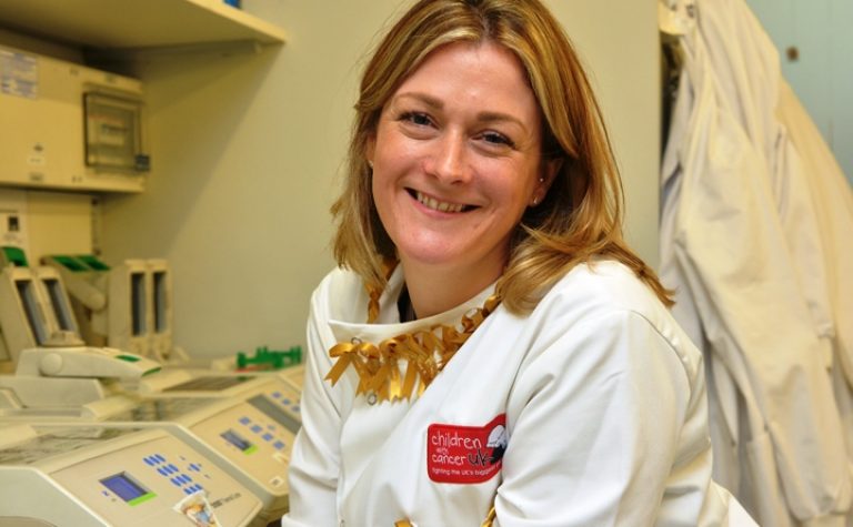 Researcher smiling wearing a lab coat