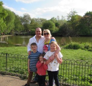 family standing by lake