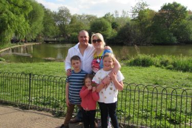 family standing by lake