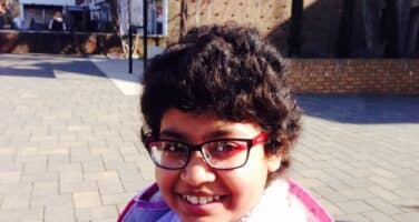 girl with glasses and pink top