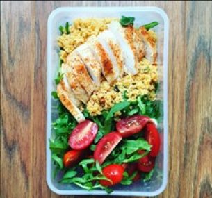 Lunch box with salad tomatoes and rocket