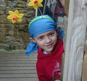 young girl wearing a scarf and smiling